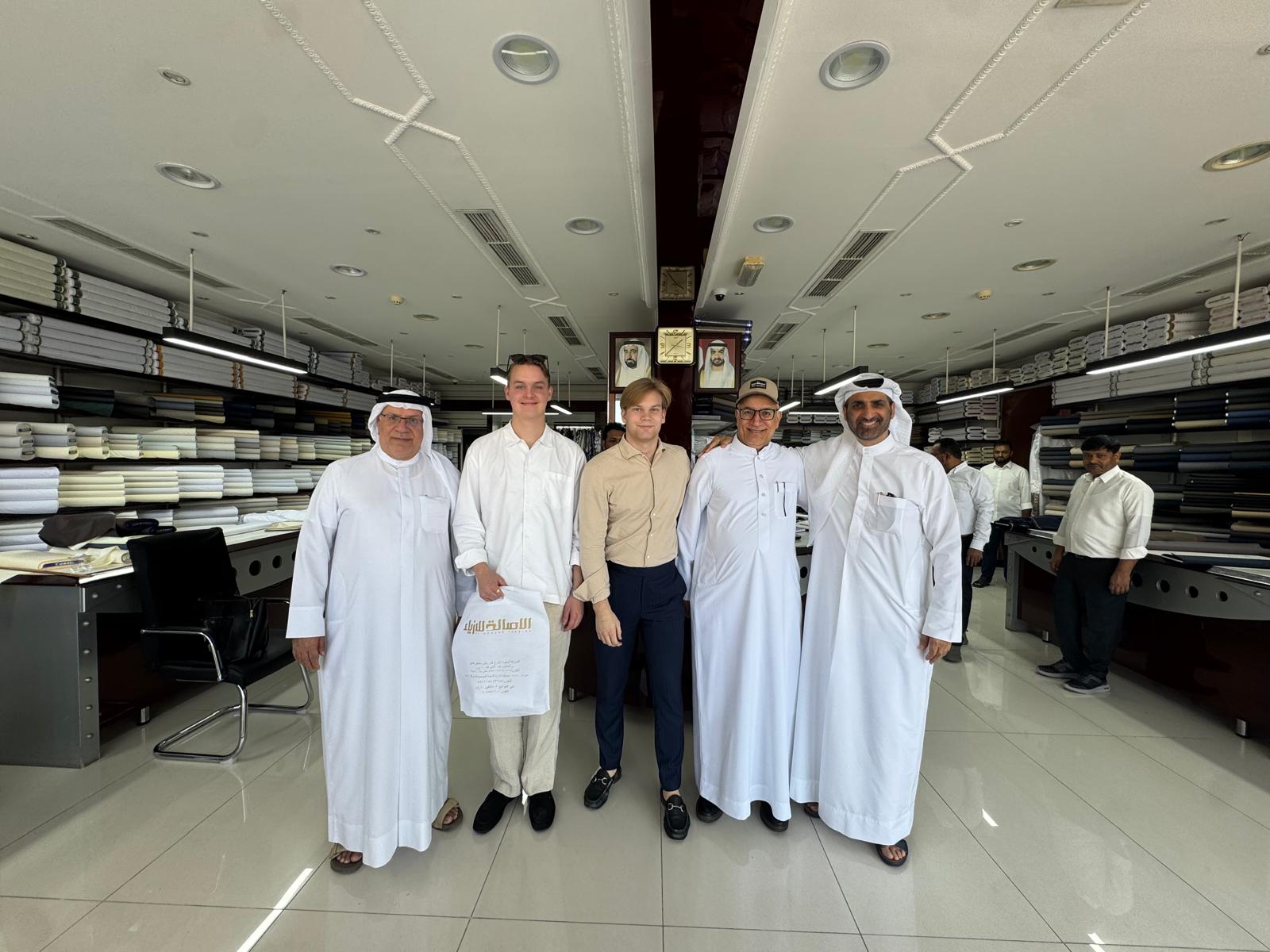 Finnish participants welcomed by Emirati hosts in a family textile house