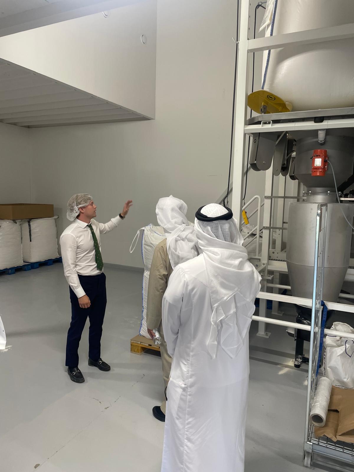 Visiting delegates touring a Finnish production facility